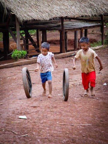 akha children playing with tyres